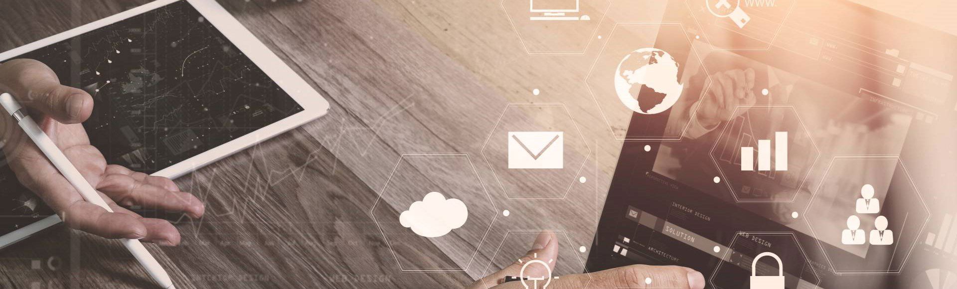 Futuristic 3D icons in focus with people working on tablets in the background.