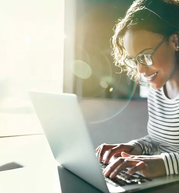 Smiling woman working on her laptop