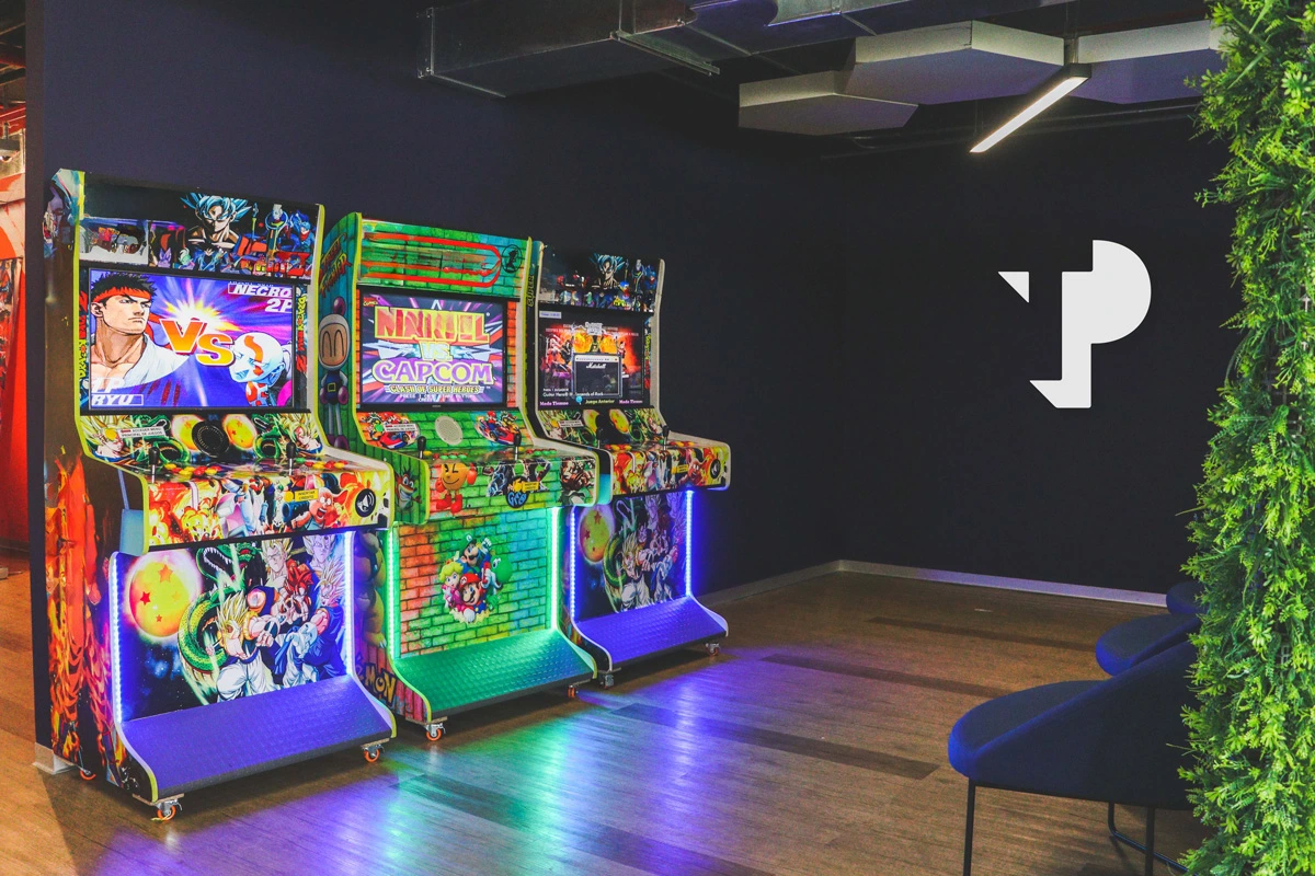 Colorful arcade game machines in a modern TP recreation area.