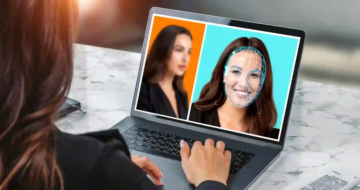 Woman browsing her laptop, detecting possible deepfake frauds