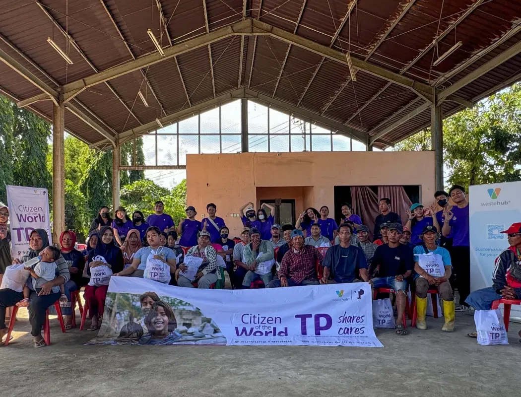 A diverse community gathers for a TP Cares charity event outdoors.