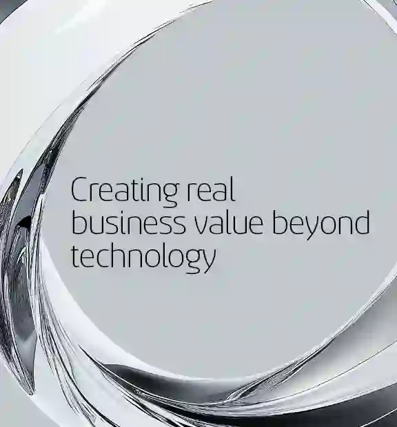 Abstract metallic ring structure surrounding the text 'Creating real business value beyond technology' on a light gray background.