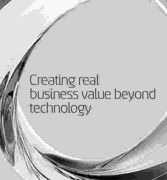 Abstract metallic ring structure surrounding the text 'Creating real business value beyond technology' on a light gray background.