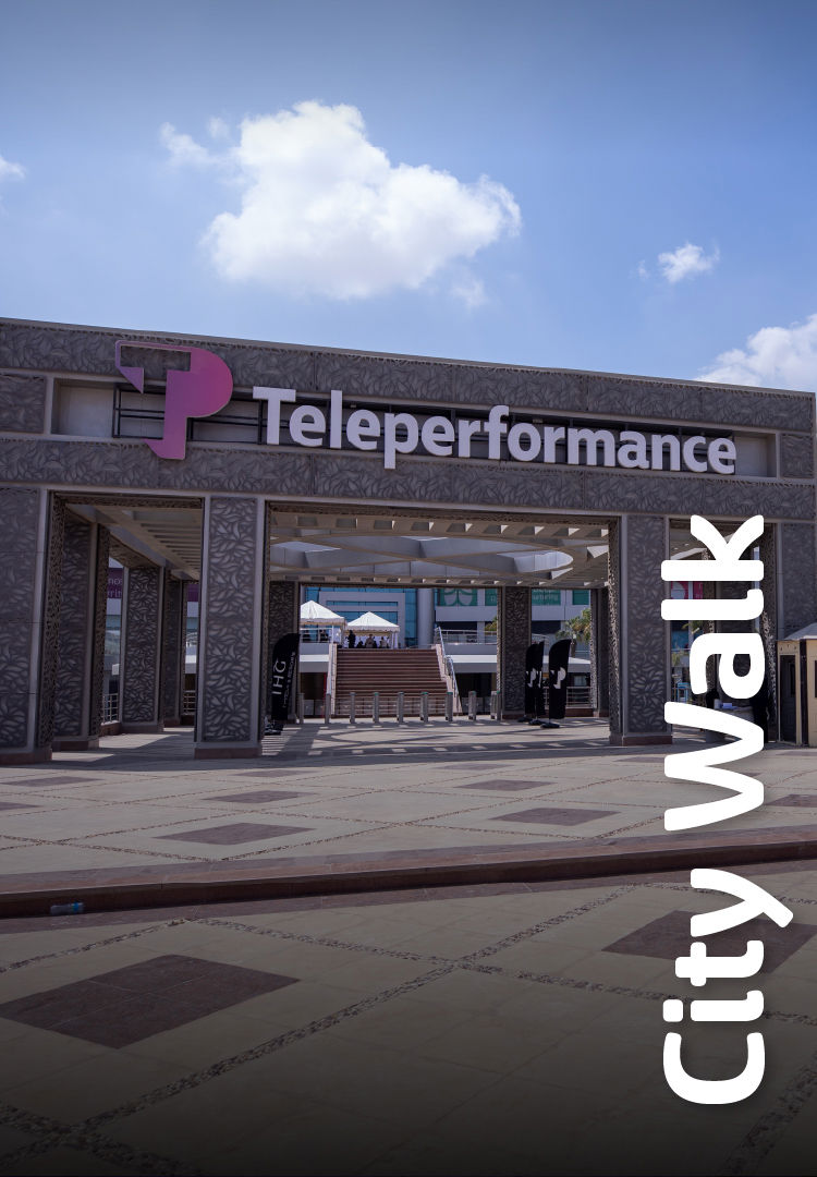 entrance archway with a TP sign, featuring a pink and purple logo. stairs lead to a building, surrounded by open space. text reads "city walk" vertically on the right. entrance archway with a TP sign, featuring a pink and purple logo. stairs lead to a building, surrounded by open space. text reads "city walk" vertically on the right.