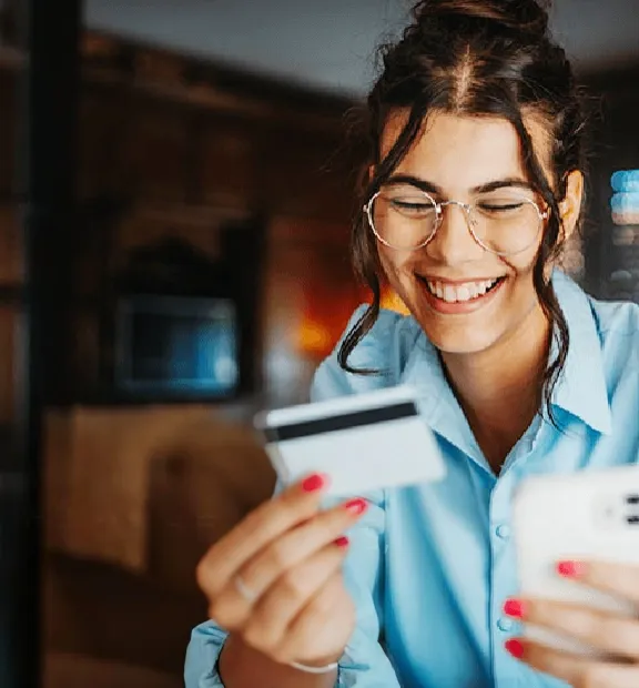 Woman with a smartphone and a card in her hand