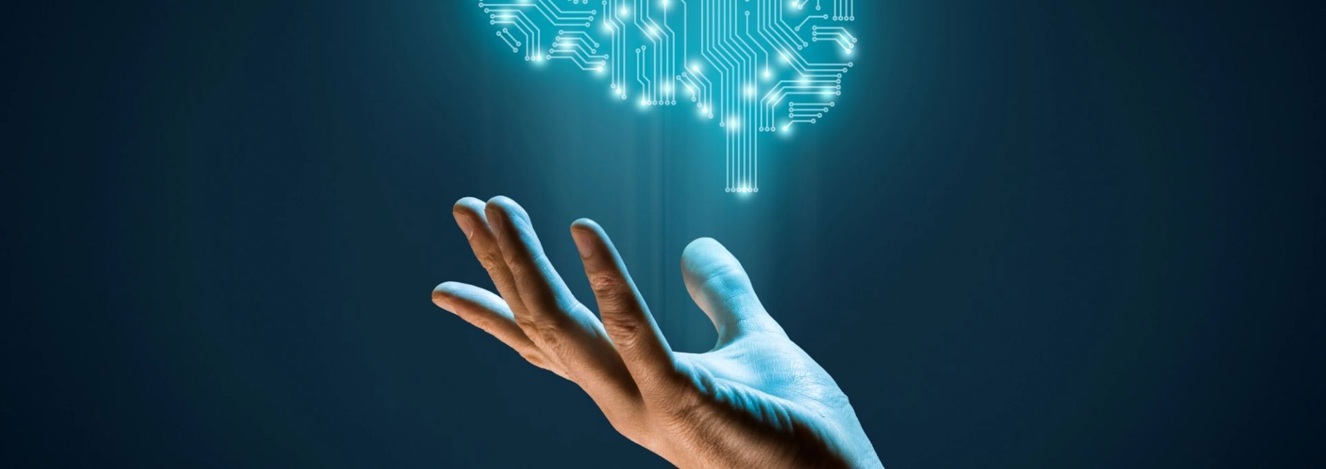 An open palm holds a glowing circuit brain symbolizing artificial intelligence technology.