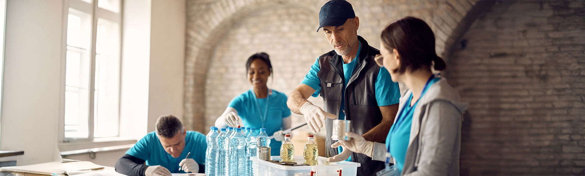 Volunteers organizing community donations for a corporate social responsibility initiative.