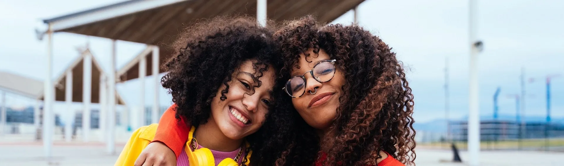 Two young colleagues embrace, symbolizing TP’s stand against violence toward women.