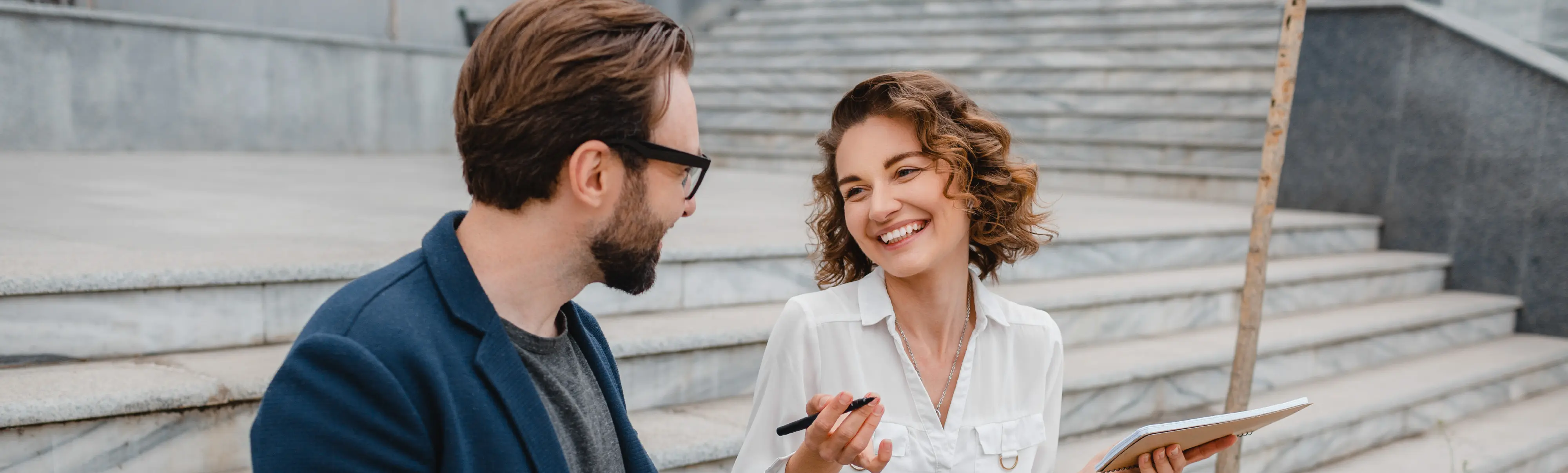 Two professionals discussing AI strategy in a collaborative setting.