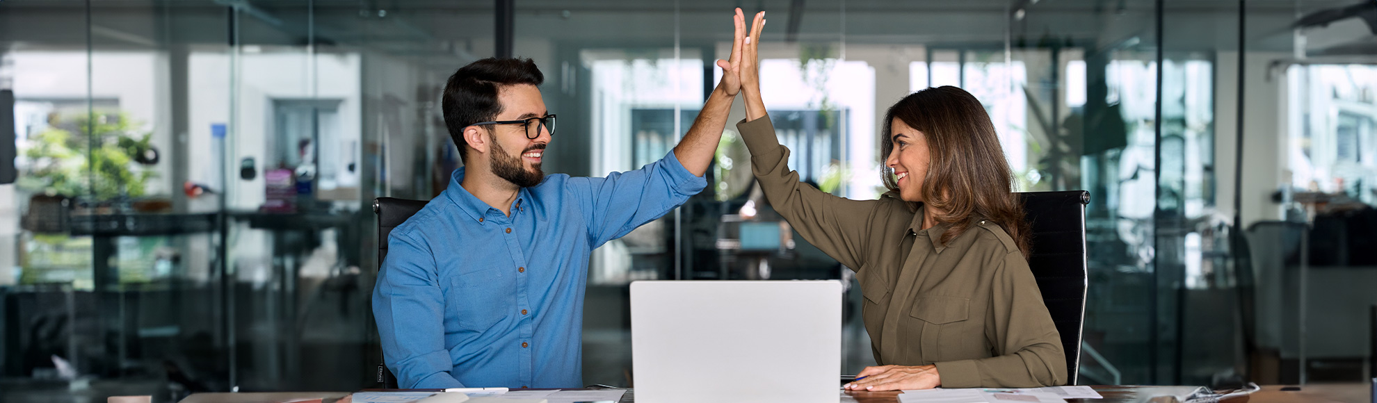 Happy business team two employees give high five celebrate professional success.
