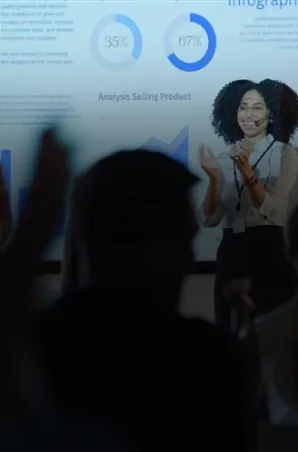 Business presenter explaining data insights to an audience using a projected infographic.