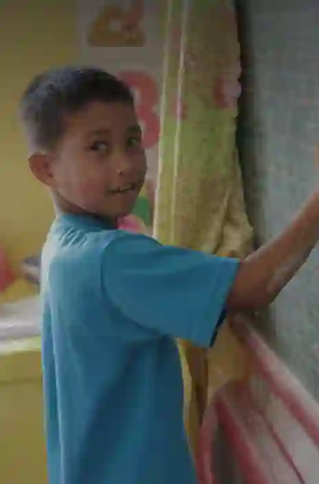 Student writing on board
