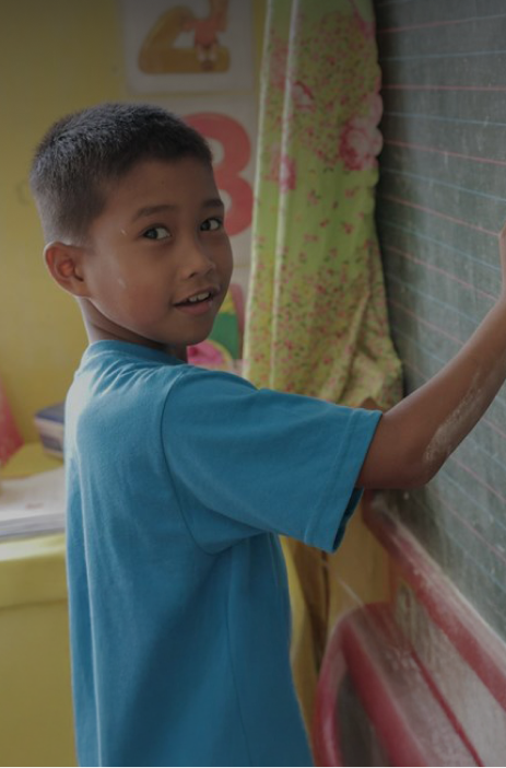 Student writing on board