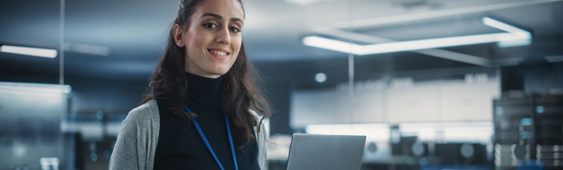 A woman smiling in a server room A woman smiling in a server room