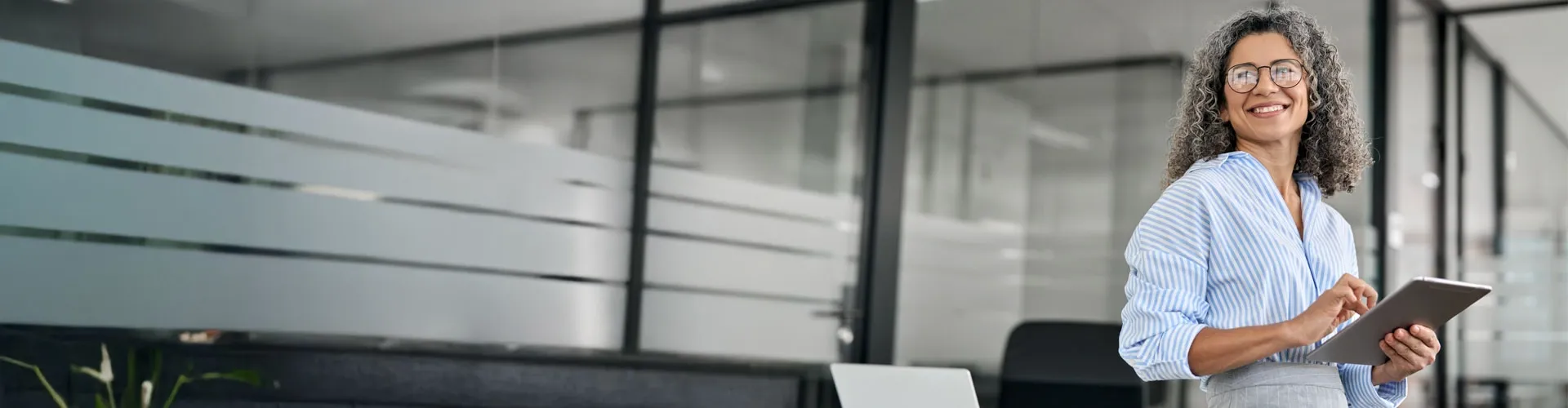 Woman in a office with a tablet in her hand