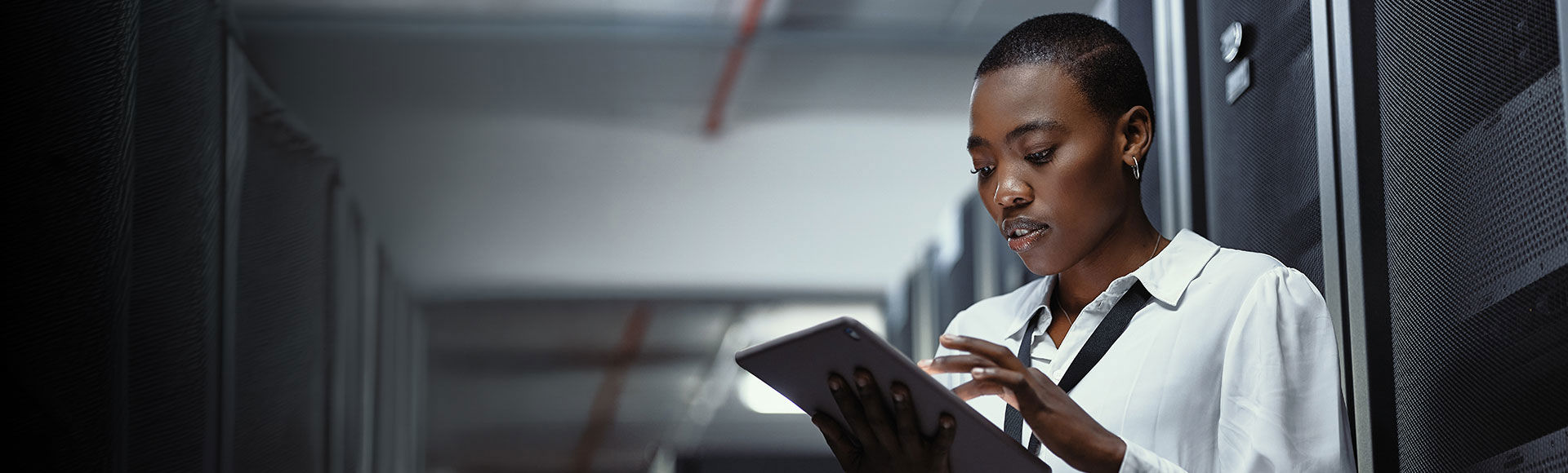 Afro descendant professional working in a modern data center environment.