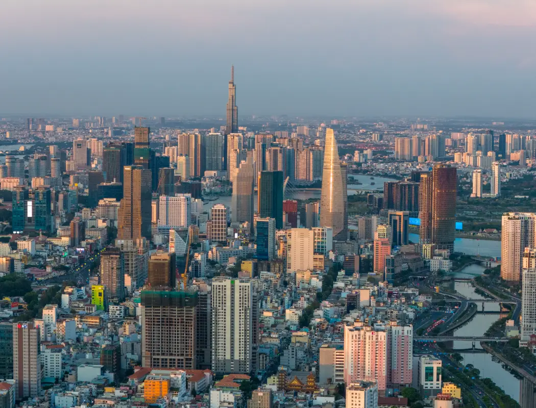 Aerial view of a vibrant modern city skyline at sunset.