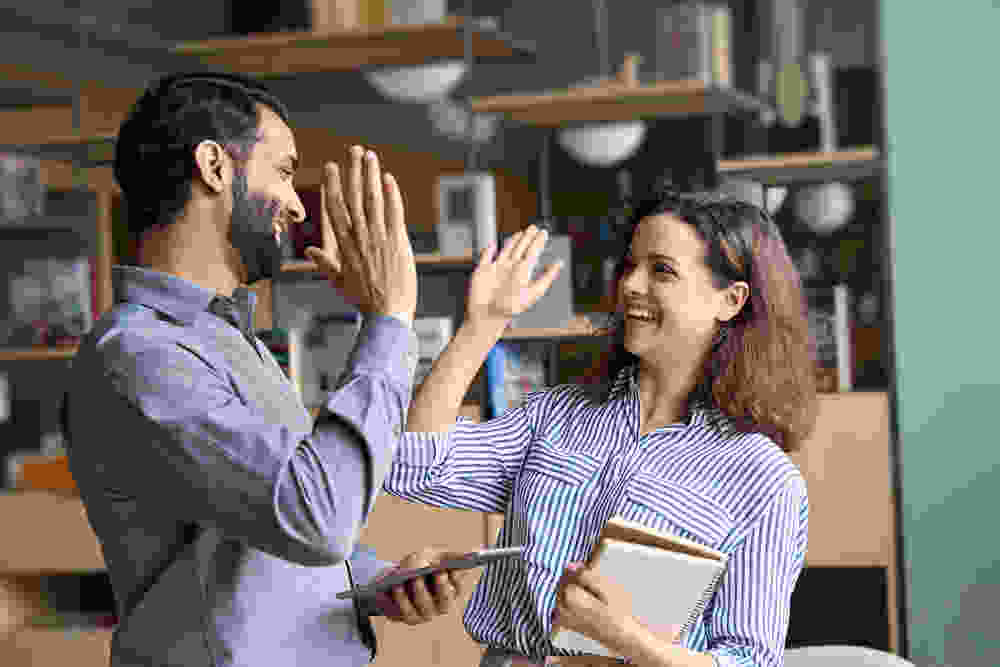 Team members celebrating with a high five