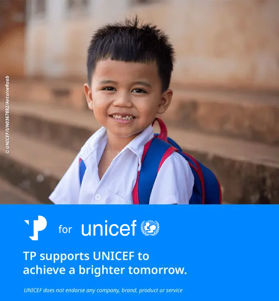 Smiling young boy, next to a blue UNICEF banner with the message supporting a brighter tomorrow.