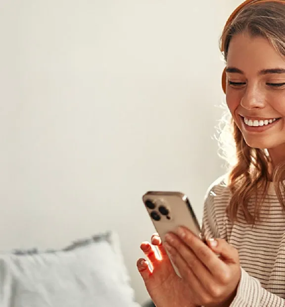 Smiling girl listening to music on her headphones