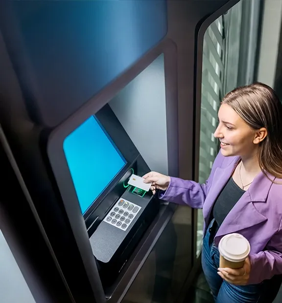 Young woman withdrawing cash from an ATM.