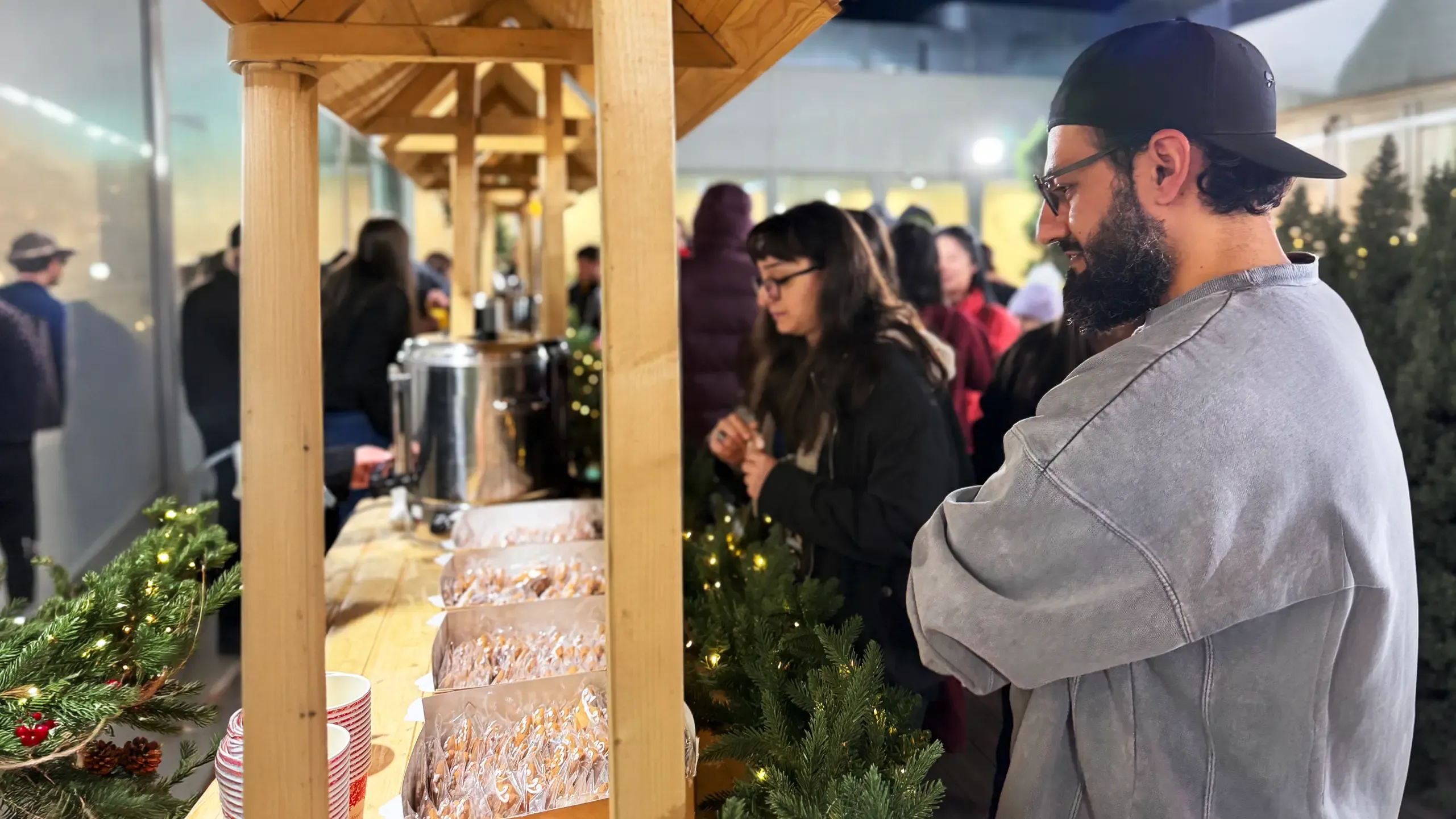 TP team member serving refreshments at a community event with volunteers and attendees.