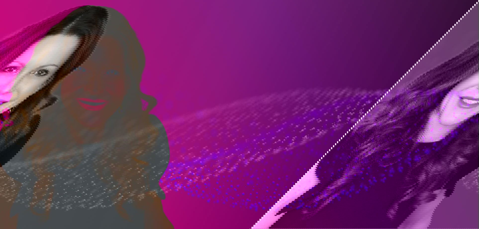 Smiling woman with long curly hair in black dress against a purple digital background with abstract particles