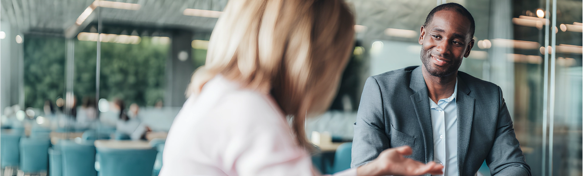 Customer service representative speaking with a client in a modern TP office.