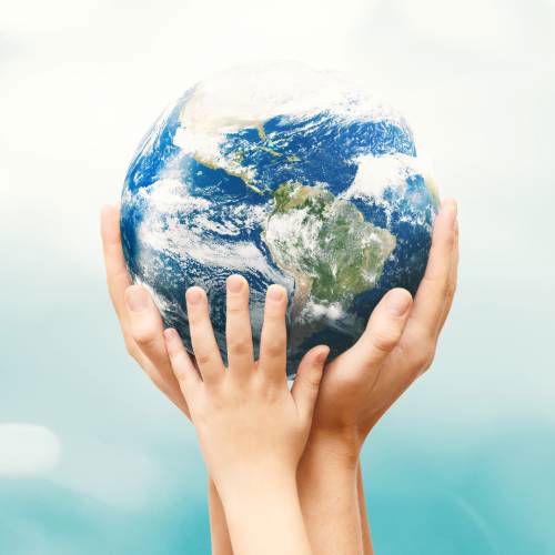 Hands cradle a model of earth, symbolizing protection and care. the background is a gradient of soft blues and whites, suggesting a peaceful, sky-like setting.