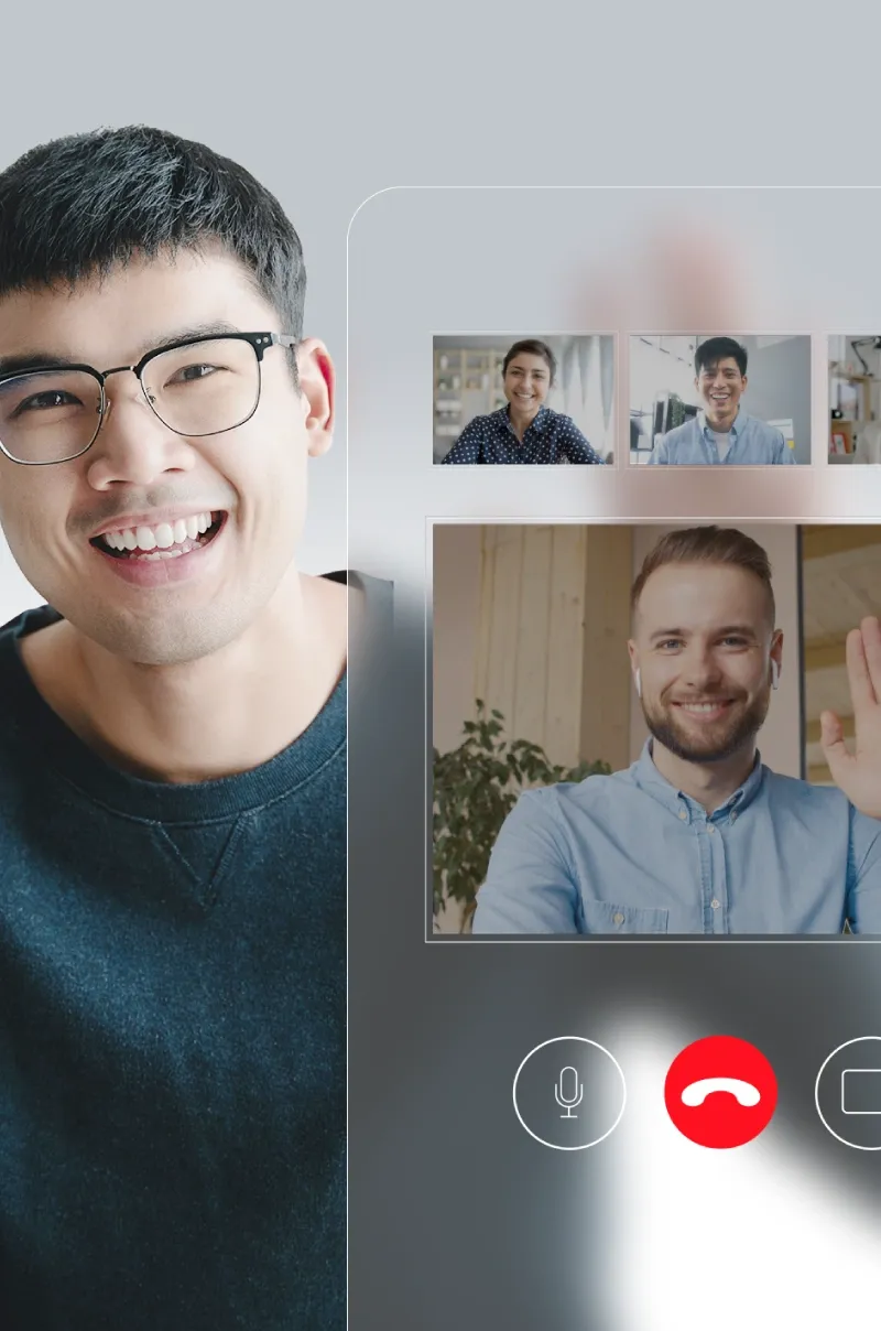 Diverse coworkers smiling and waving during a video call. 