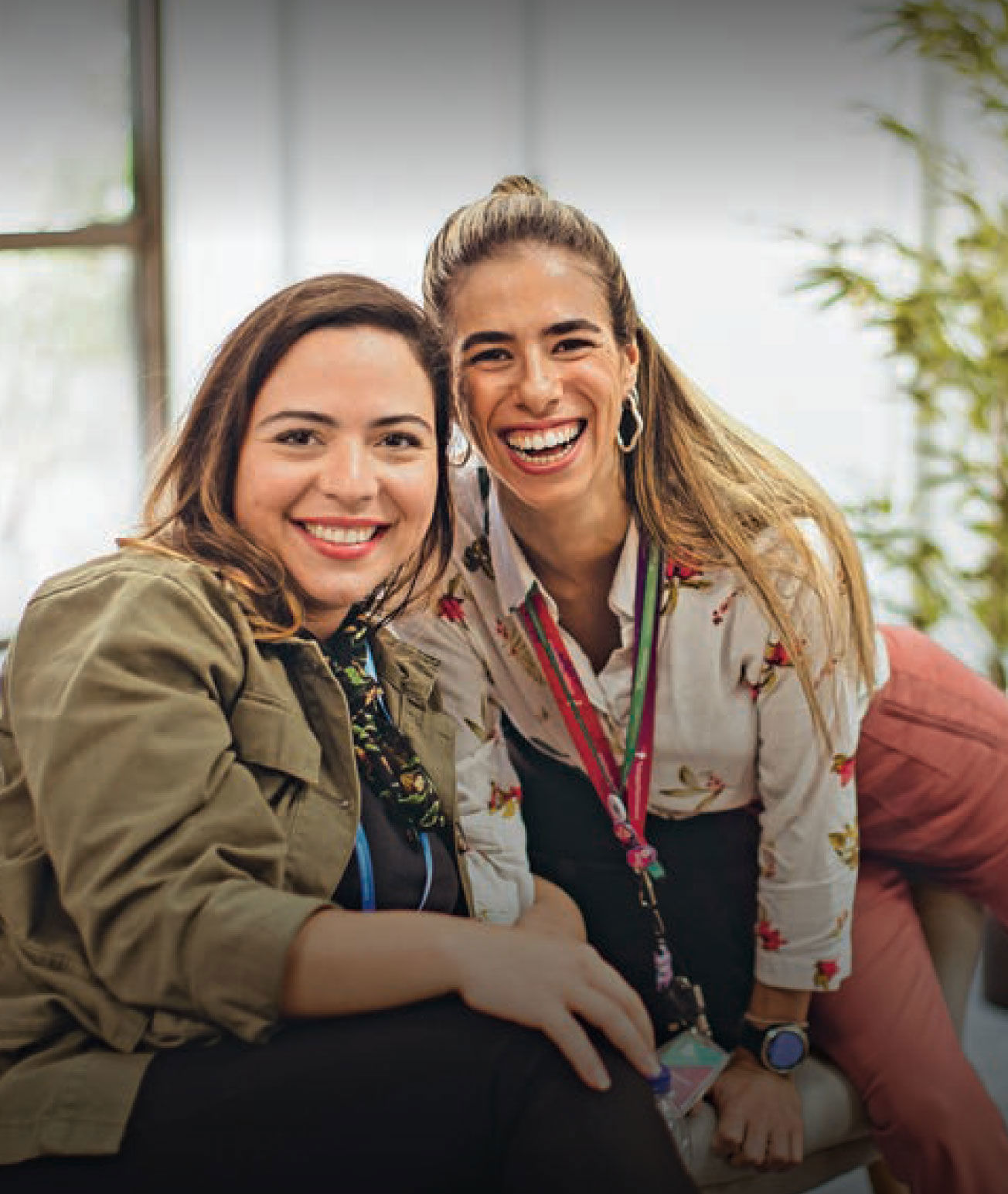 TP employees smiling and looking at the camera during a workday at the company’s office.