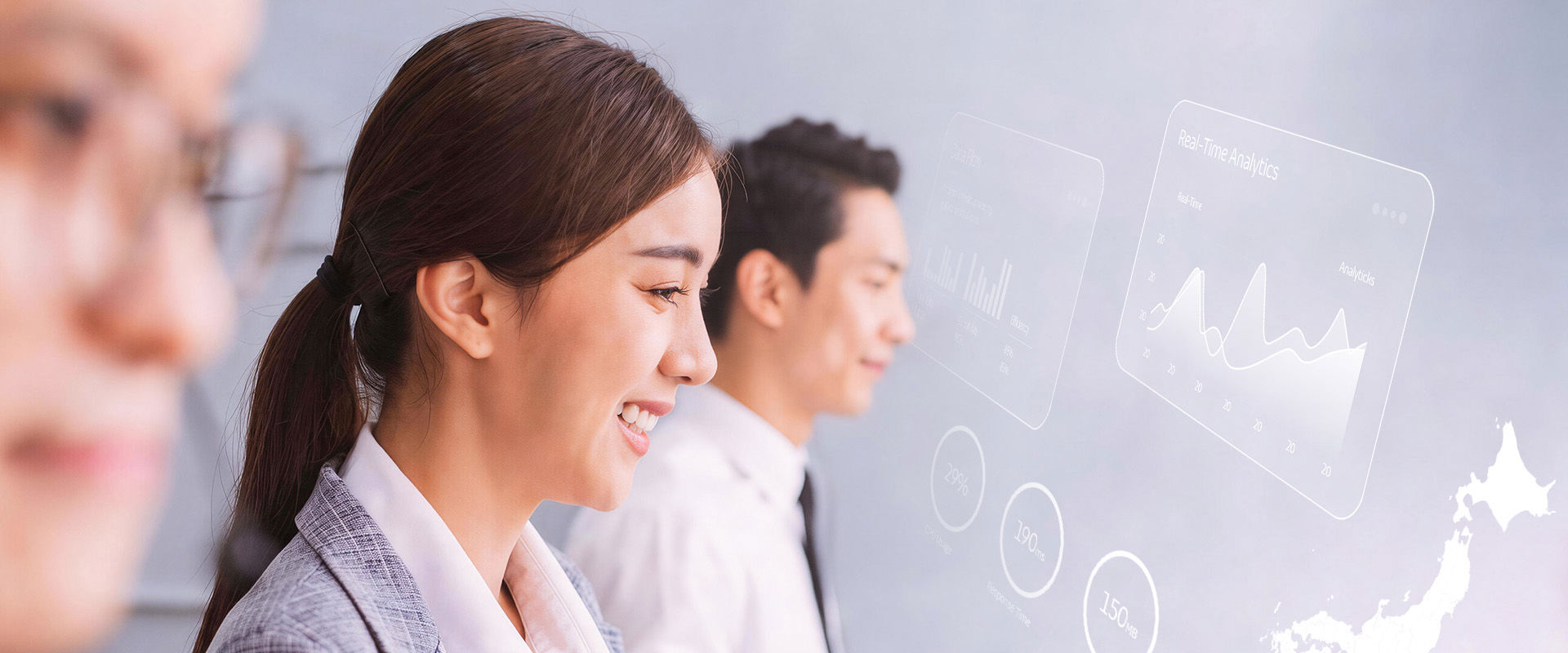 Smiling customer‑service agents work with real‑time digital data charts.