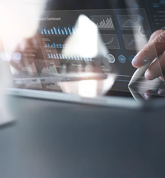 Person analyzing data on a transparent digital dashboard, highlighting analytics in a modern finance and accounting setting.