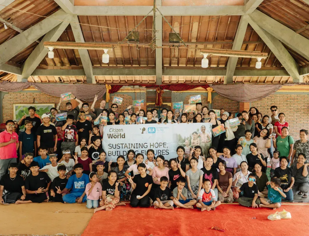A diverse community group poses together for a charity event photo.