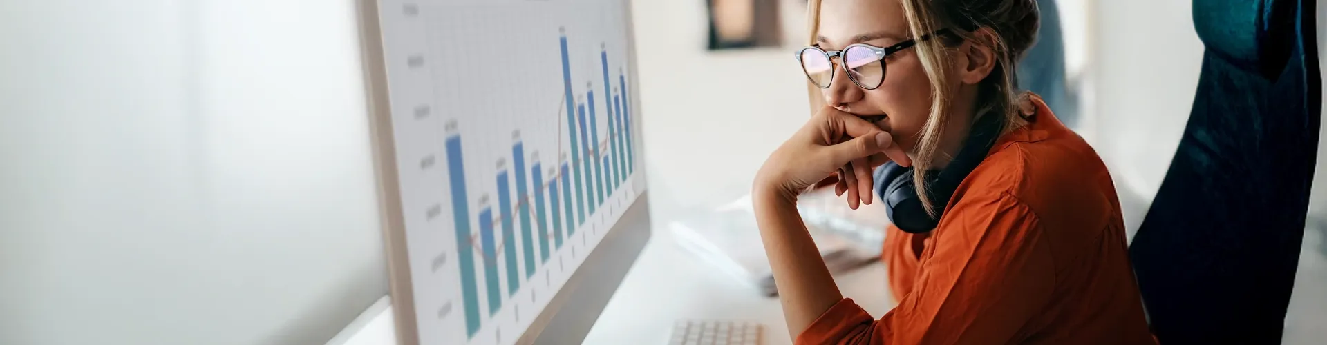 Professional analyzing data charts on a digital screen, illustrating advanced analytics insights.