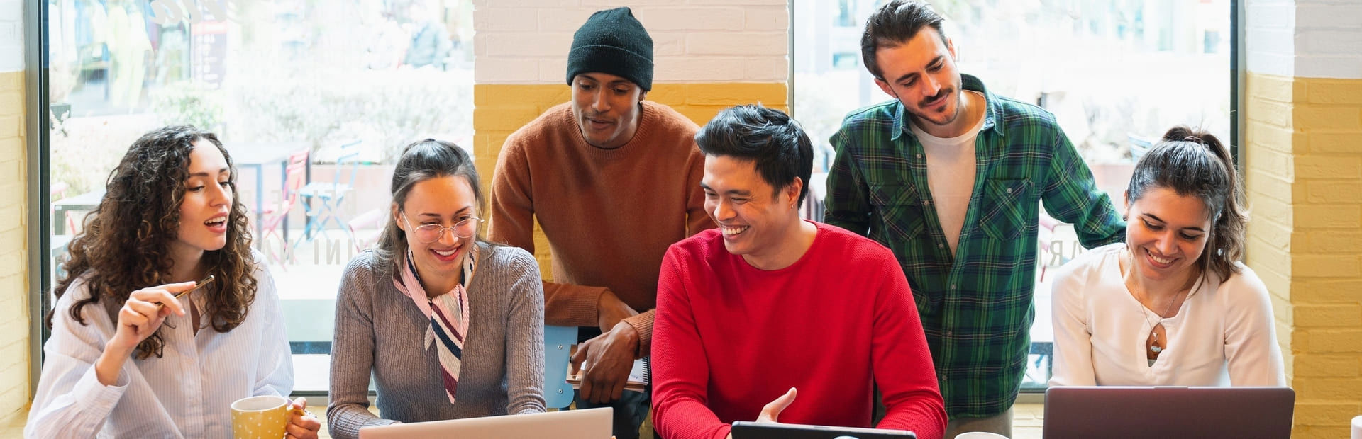 Diverse group of young professionals talking at work, reflecting a modern, collaborative, and AI-forward mindset.