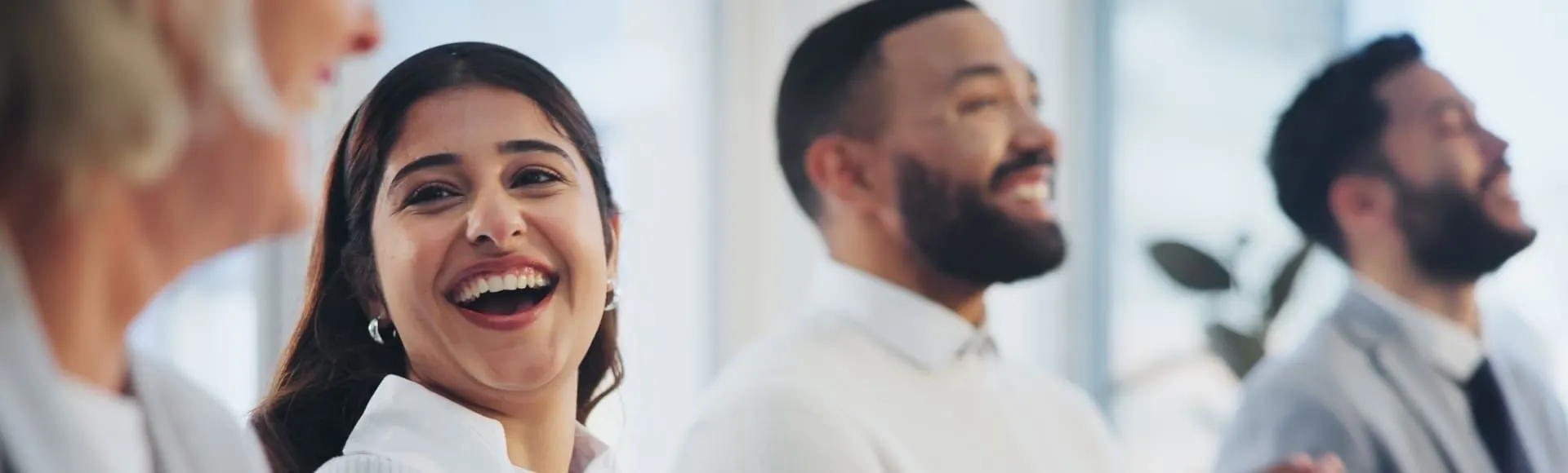 Coworkers celebrating a collective award, representing TP’s recognition and team achievements.