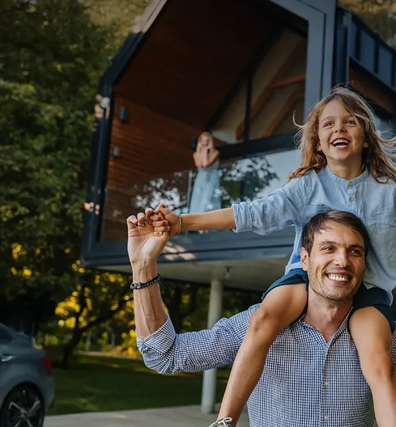Father carrying his daughter on his shoulders while they play together.
