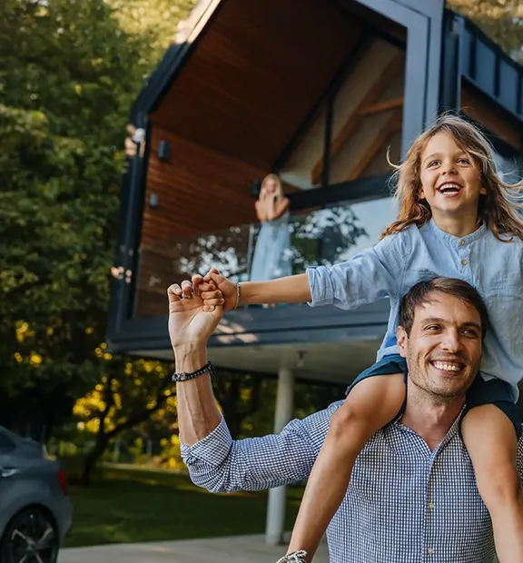 Father carrying his daughter on his shoulders while they play together.