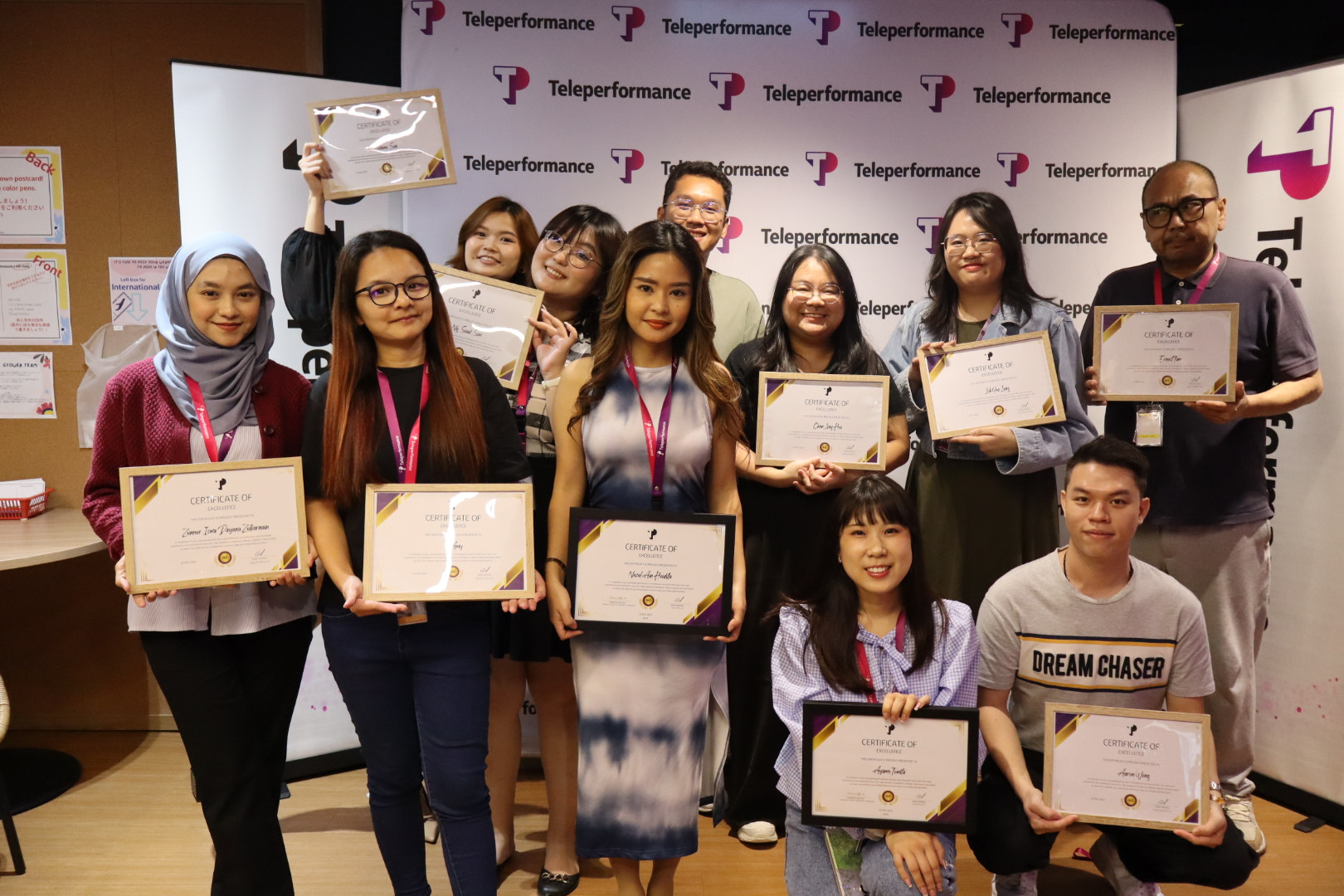 TP employees posing with certificates at recognition event