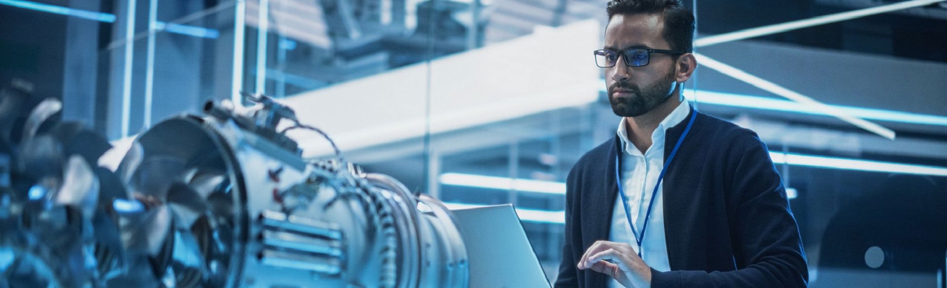 Focused employee working on computer inside high-tech office