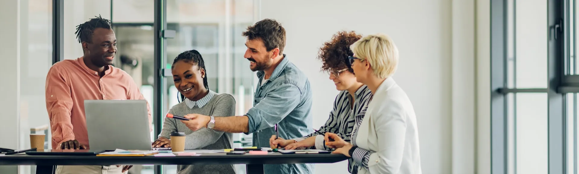 A Sales team planning strategies during a collaborative office meeting.