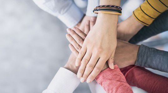 Hands stacked together