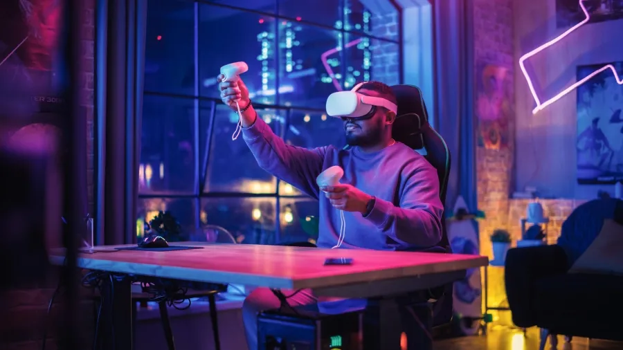 Person using a virtual reality headset and controllers while gaming in a modern room.