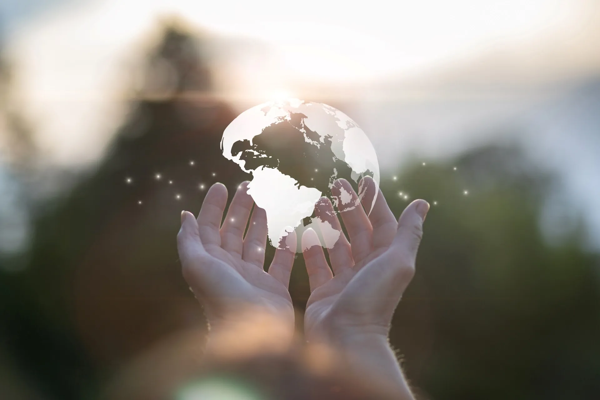 Hands holding a glowing globe symbolizing global responsibility and sustainability.