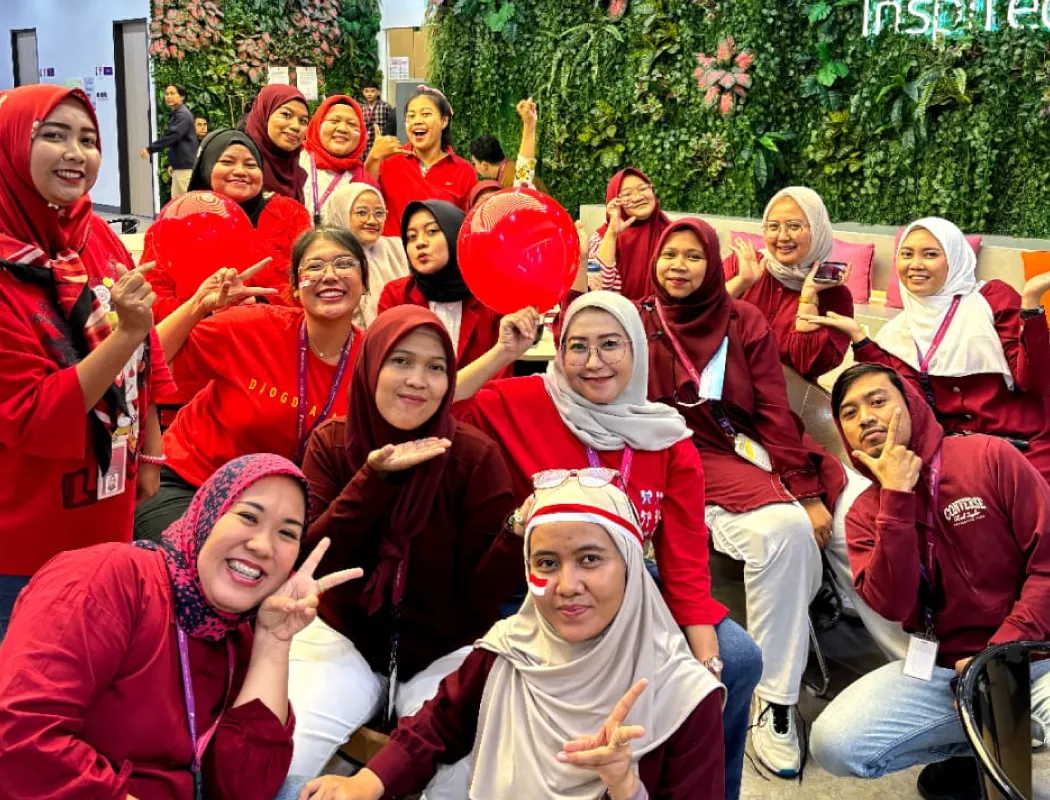 A group of people celebrate Indonesia's independence day in red attire.