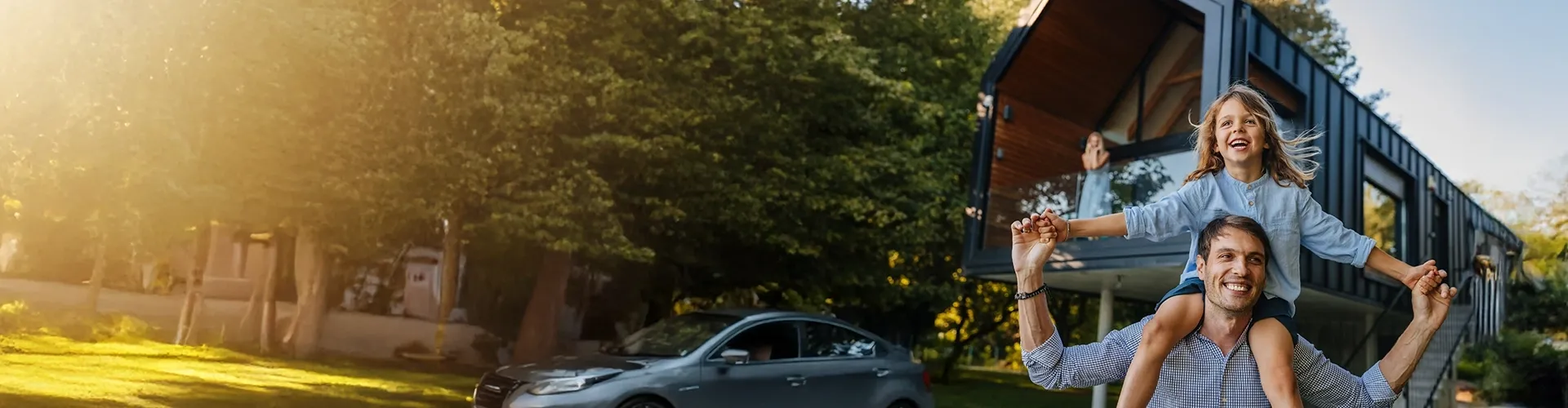 Father carrying his daughter on his shoulders while they play together.