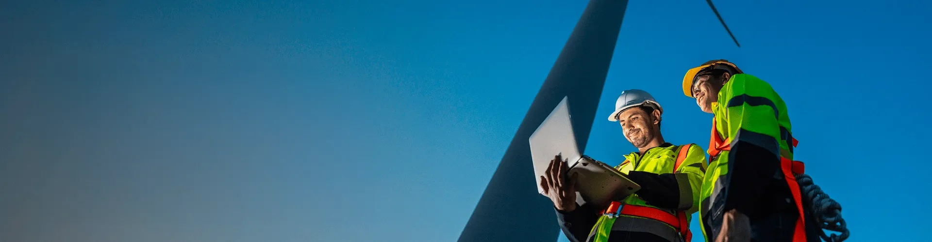 Wind power tower operators working on computer