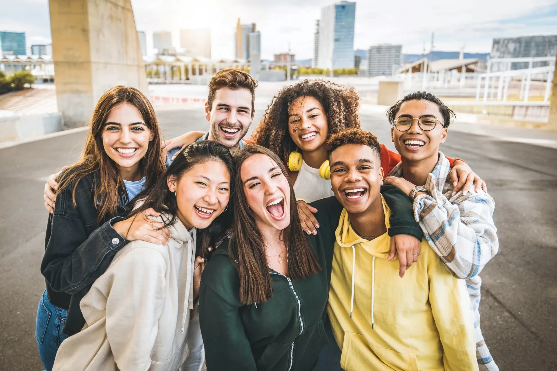Group of young people smiling and posing together outdoors.