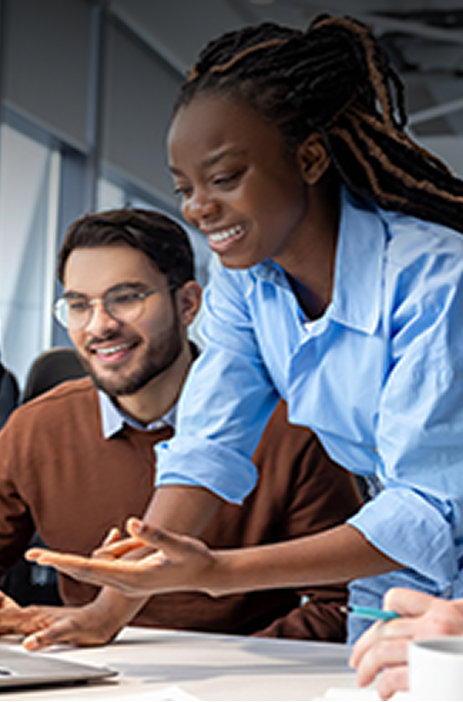Woman working on computer with colleagues